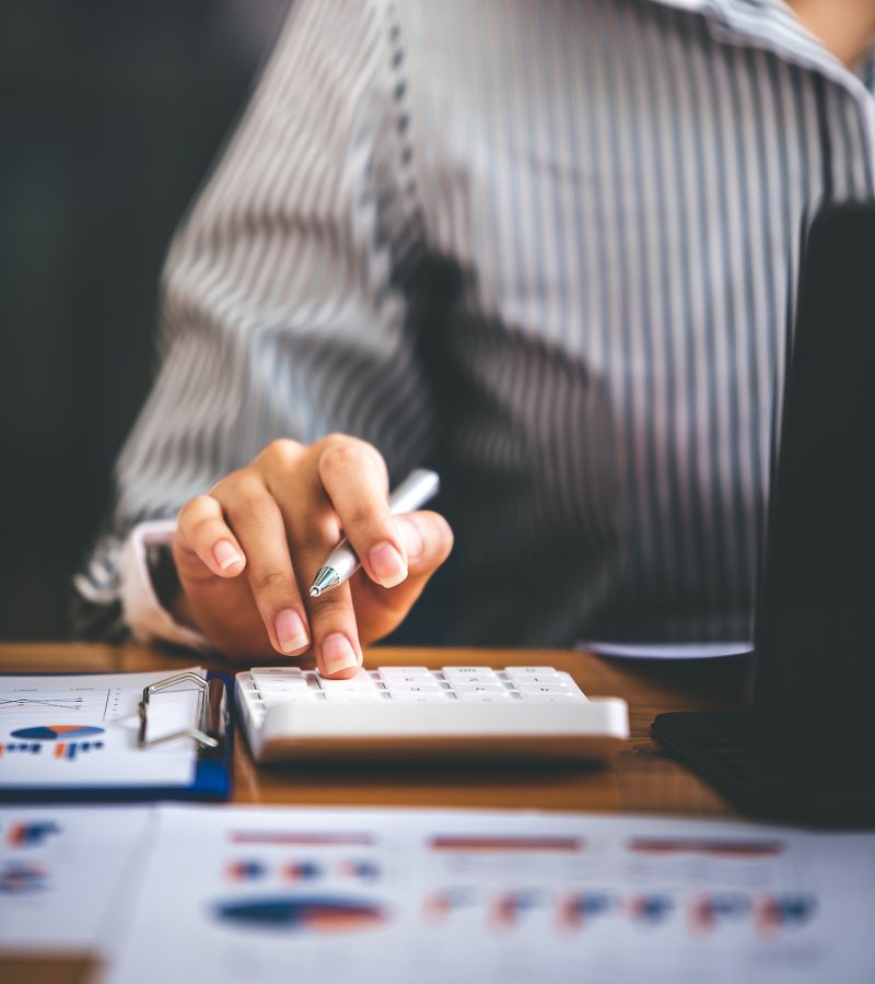 business woman or accountant who are using a calculator to calculate business data Accounting docume