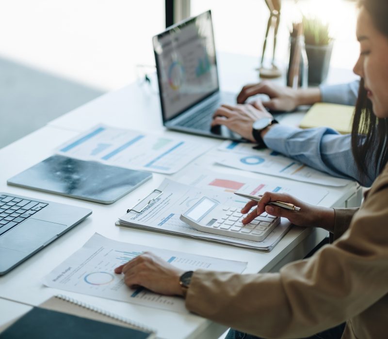 businesswoman accountant hand working on calculator to calculate financial data report, accountancy